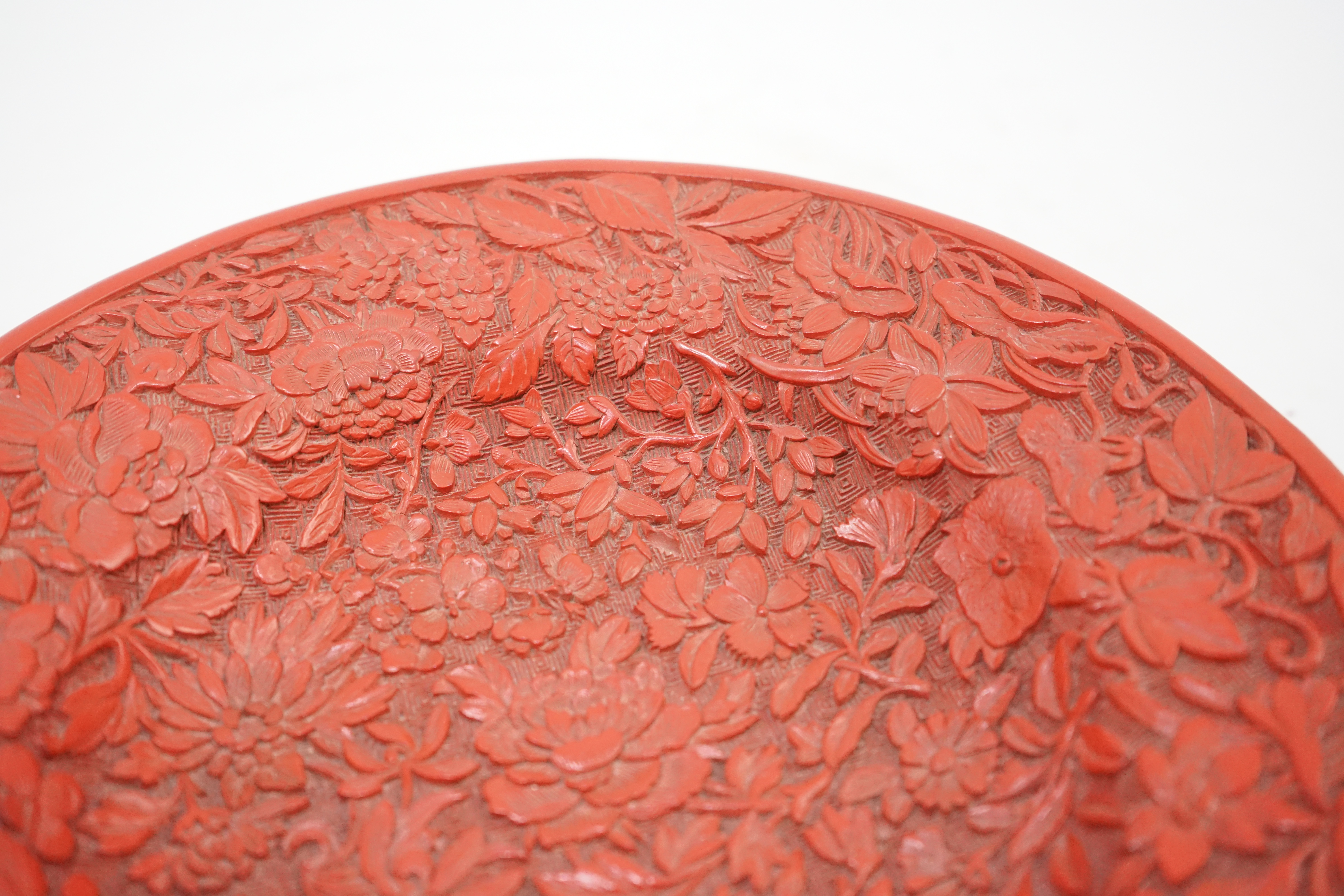 An unusual Chinese cinnabar lacquer ‘thousand flower’ footed dish, 18th/19th century